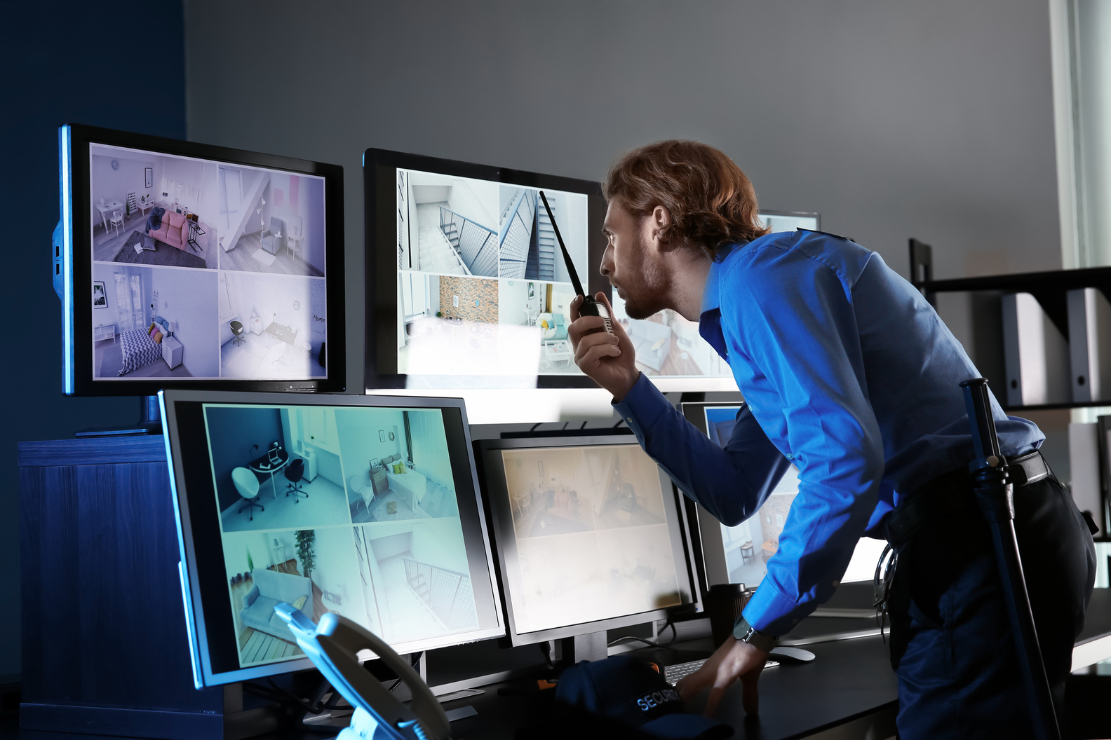 Security Guard Monitoring Modern CCTV Cameras in Surveillance Room